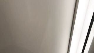 Hot chick is trying on clothes in the fitting room, assisted by a sales assistant