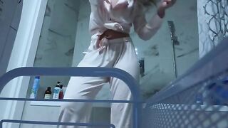 A petite girl caresses her pussy in the bathroom, no one sees it