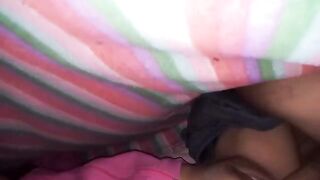 An amateur couple has sex under the sheets, with a big ass shining through