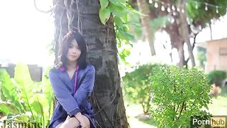 A cute Asian girl wets her pussy in the garden with a vibrator