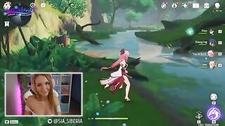 A gamer girl streams herself playing Genshin Impact with a huge toy