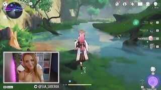 A gamer girl streams herself playing Genshin Impact with a huge toy