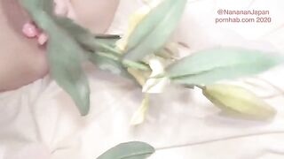 A girl in a neat floral dress has flowers put in her ass