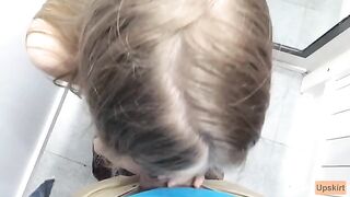 The petite girl was almost caught while giving a blowjob in a shop changing room