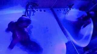 A blonde is indulging in bathroom fun with toys and more