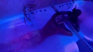A blonde is indulging in bathroom fun with toys and more