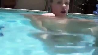 Babe in bikini puts her ass under water and inserts a dildo into it