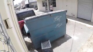 The couple got intimate behind the garbage tank