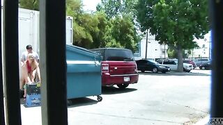 The couple got intimate behind the garbage tank