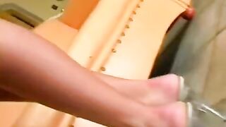 Beautiful woman masturbating on a leather chair