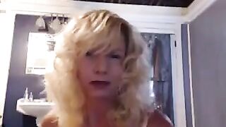 A aged woman caresses herself in the bathroom pleasantly