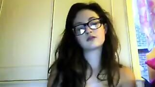 A cute student with glasses takes off her clothes during a video call