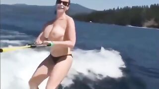 Topless girl skiing on the water surface, a thrilling sight!