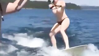 Topless girl skiing on the water surface, a thrilling sight!