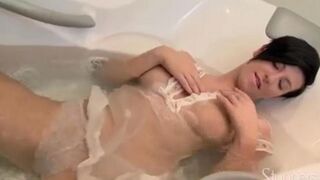 A lonely pregnant brunette masturbates on the couch with her hand