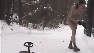Nude girls are having fun with snowballs in the street