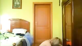 A couple has a private moment at home, unaware they're being watched