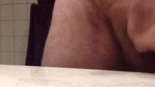 A guy caressed sperm and lower lips while working at the table