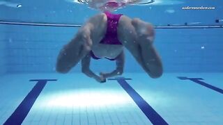 Nude beauty has fun in the pool and shows her forms