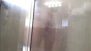A man washes himself in the shower, but there's a camera