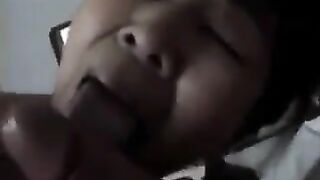An adult Chinese woman practices her blowjob skills on a man’s dick