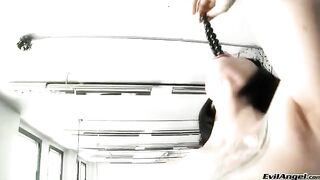 A cute girl plays with balls and vagina in high heels