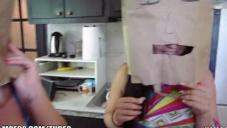 The girls wear bags on their heads and engage in steamy action