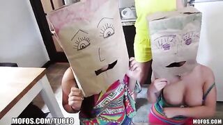 The girls wear bags on their heads and engage in steamy action