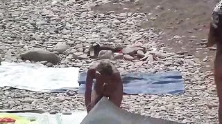 A couple of free-spirited lovers on a nudist beach