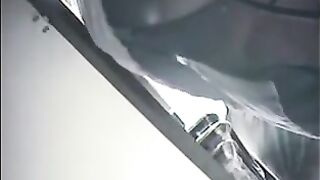 A hidden camera at the checkout in the store shoots girls under their skirts