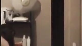 He admires himself in the mirror, completely naked and ready to go