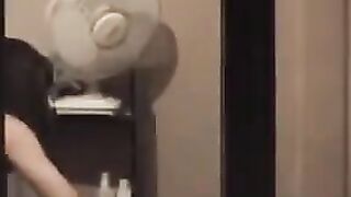 He admires himself in the mirror, completely naked and ready to go
