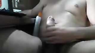 Guy jerks his cock while sitting in front of a computer