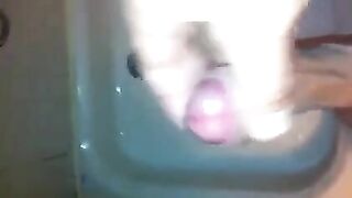 The kid caresses himself with his hand under the shower, aiming for a climax