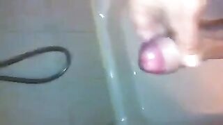 The kid caresses himself with his hand under the shower, aiming for a climax