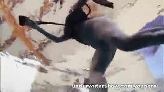 A naked girl is having fun in the swimming pool
