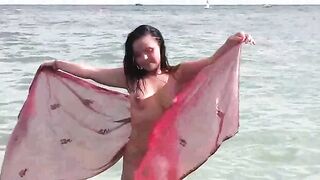 A hot girl is bathing naked in the sea