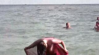 A hot girl is bathing naked in the sea