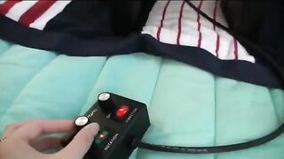 Three girls are having fun with a vibrator