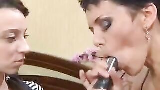 A mother is giving a lesson to her daughter on how to perform a blowjob