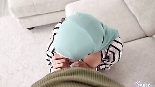 A guy is fucking a hot girl with a hijab on the couch