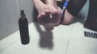 In the shower, a little girl plays with her pussy with her fingers and a toy