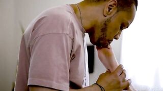 Blonde woman licked by a black man with a tattoo, embodying passion