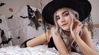 A cute witch in a pink dress waits for magic to happen