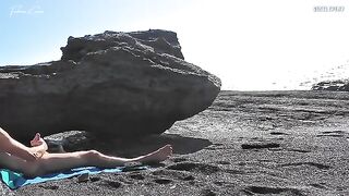 A naked girl rubs her pussy on the beach and makes a guy cum