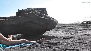 A naked girl rubs her pussy on the beach and makes a guy cum