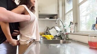 A hot brunette MILF with huge natural boobs gets fucked in the kitchen