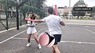 A girl is trying to get a membership in the gym, but the muscular trainer blocks her way